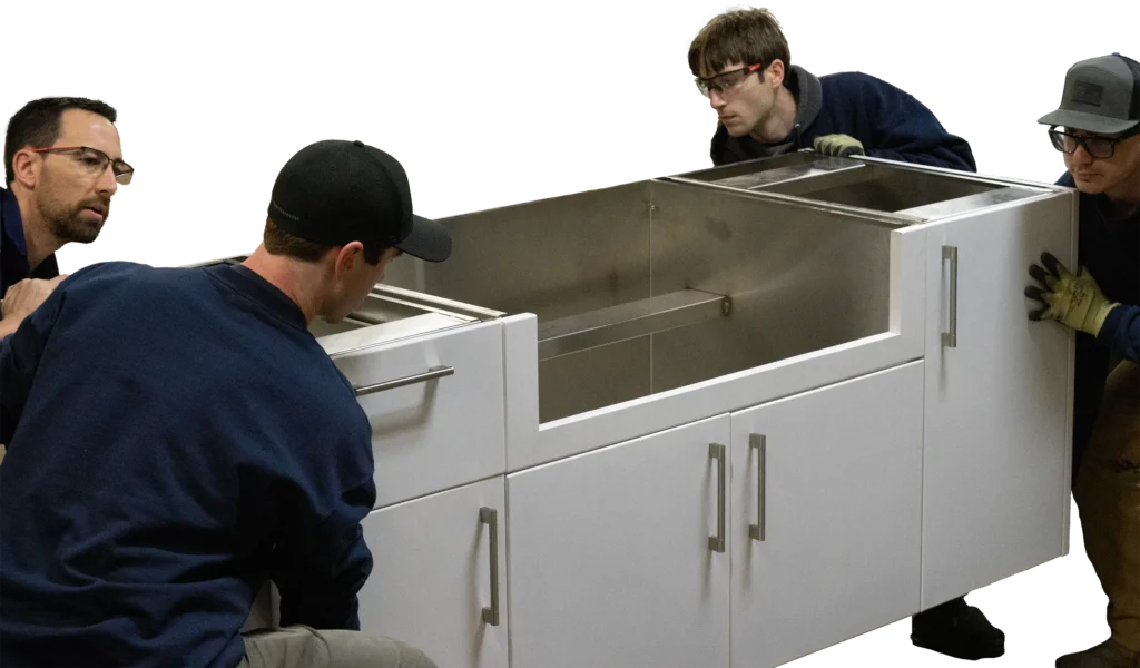 Silver Fern Stainless crew holding an outdoor kitchen in their warehouse